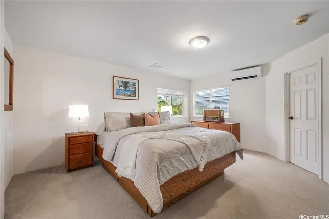 a spacious bedroom with a bed and a lamp