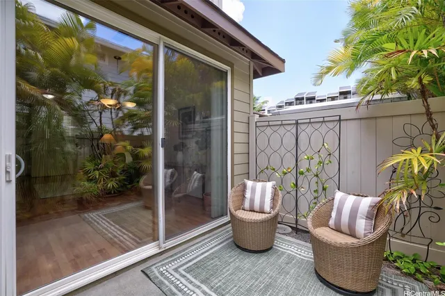 a view of a patio with table and chairs potted plants