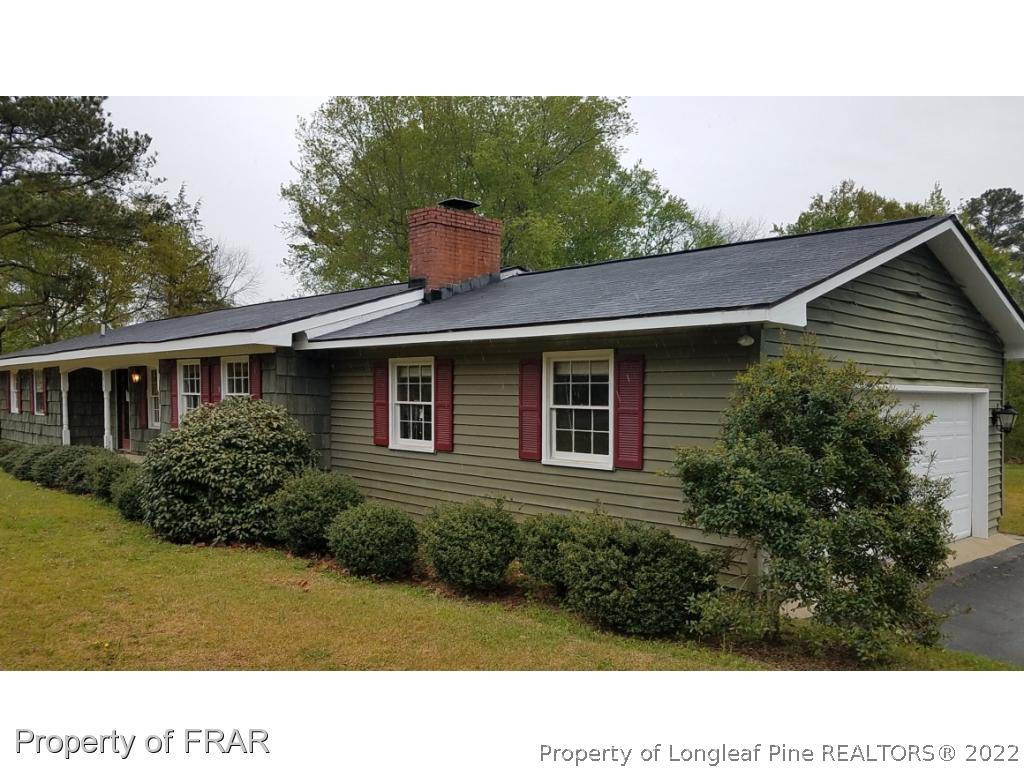 1817 Joel Road Carthage, NC 28327 - Photo 1 of 20 a black and white house with a yard