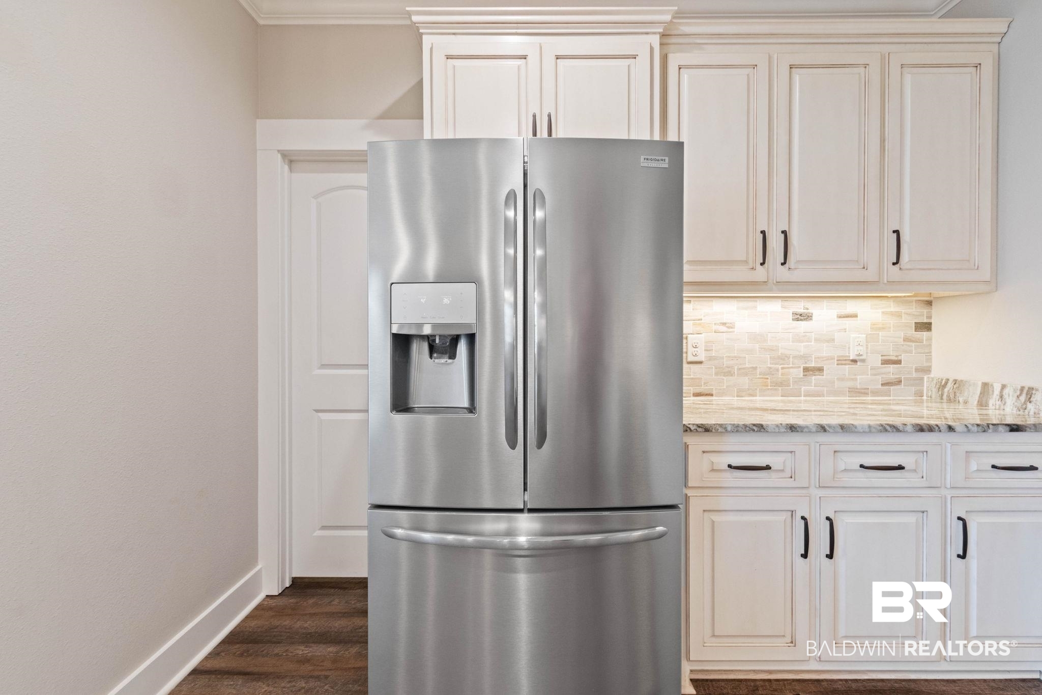 17376 Bankhead Boulevard Fairhope, AL 36532 - Photo 27 of 73 Kitchen featuring stainless steel refrigerator with ice dispenser, light stone counters, backsplash, and dark wood-style floors