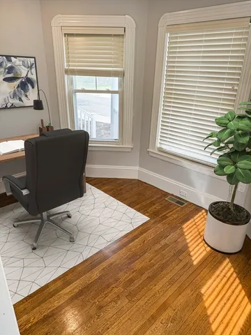 a workspace with furniture and window