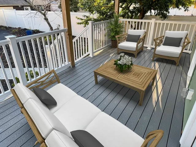 a view of balcony with wooden floor outdoor seating and wooden floor