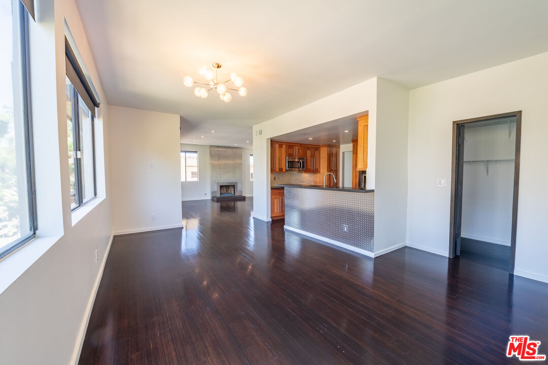 1505 Purdue Avenue, Unit 202 Los Angeles, CA 90025 - Photo 6 of 14 a view of an empty room with wooden floor and a window