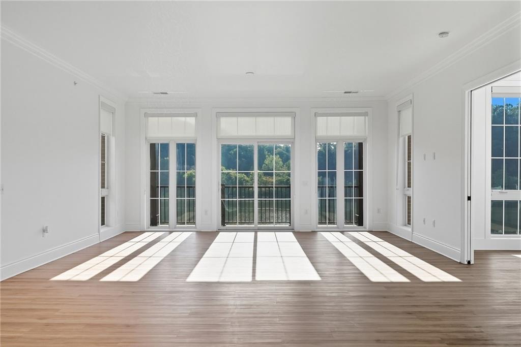 1 1st Street, Unit 407 Oakmont, PA 15139 - Photo 11 of 40 a view of a bedroom with wooden floor and windows
