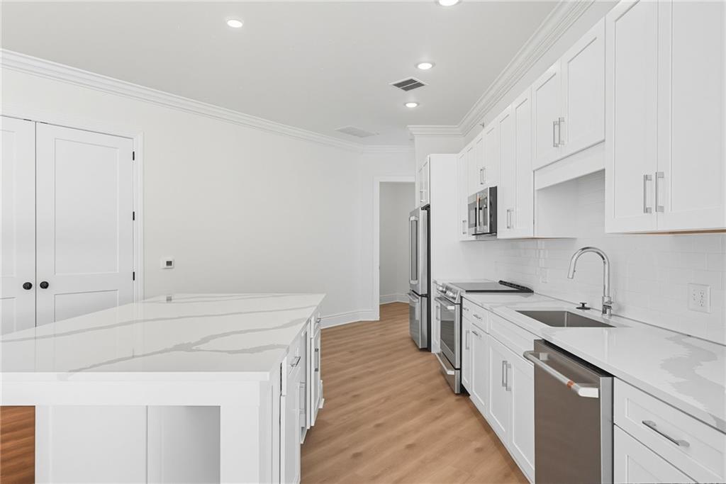 1 1st Street, Unit 407 Oakmont, PA 15139 - Photo 14 of 40 a kitchen with a sink stove and refrigerator