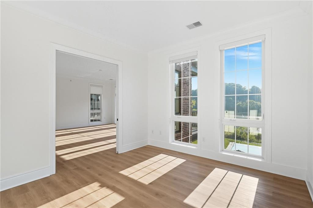 1 1st Street, Unit 407 Oakmont, PA 15139 - Photo 15 of 40 a view of an empty room with wooden floor and a window