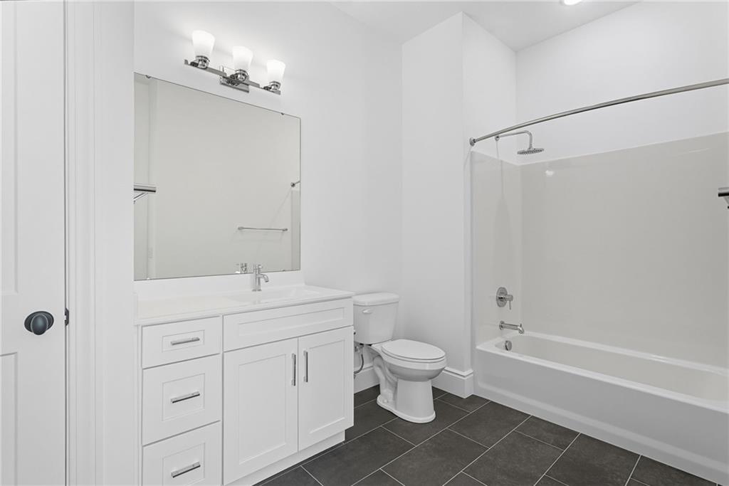 1 1st Street, Unit 407 Oakmont, PA 15139 - Photo 22 of 40 a bathroom with a double vanity sink a toilet and shower