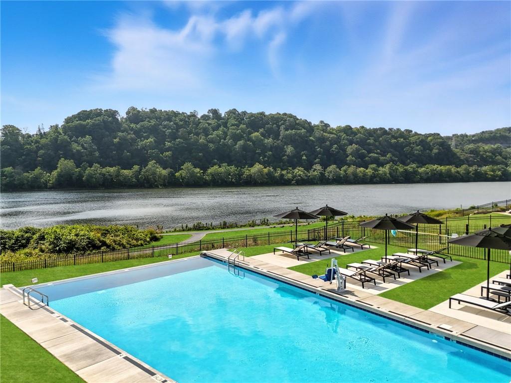 1 1st Street, Unit 407 Oakmont, PA 15139 - Photo 28 of 40 a view of a lake with houses in the back