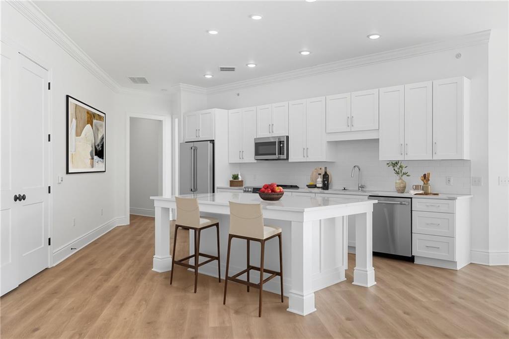 1 1st Street, Unit 407 Oakmont, PA 15139 - Photo 6 of 40 a kitchen with white cabinets and white appliances