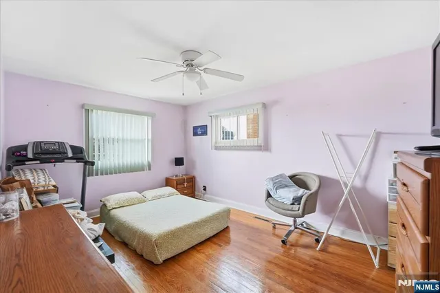 a bedroom with a bed a window and chair