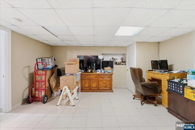 a utility room with dryer washer and a view of kitchen