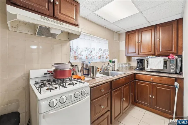 a kitchen with stainless steel appliances granite countertop a sink and cabinets