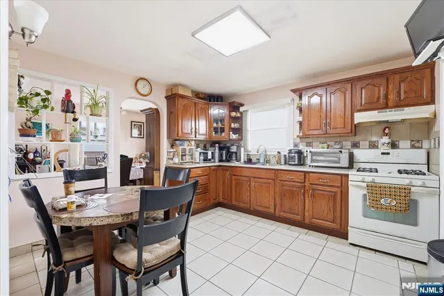a view of a backyard with a fountain plants and large tree