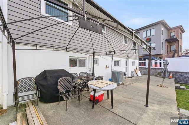 a front view of a house with swimming pool having outdoor seating