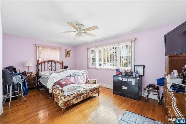 a bedroom with furniture and a flat screen tv