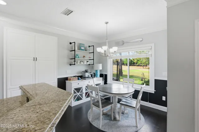 a view of an entryway with wooden floor and windows