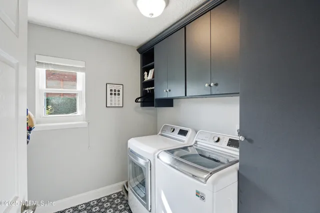 an aerial view of residential houses with outdoor space and river