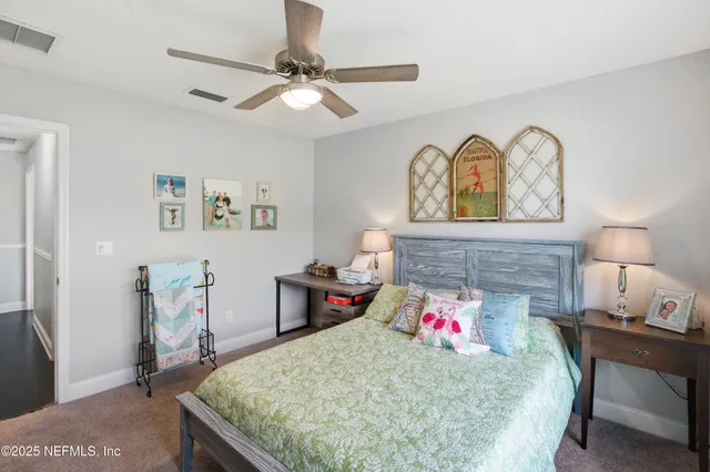 a kitchen with kitchen island a sink a stove a refrigerator and chairs