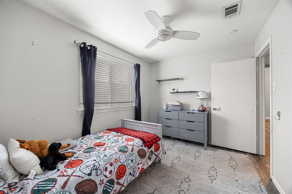 2016 Falcon Ridge Drive, Unit B Carrollton, TX 75010 - Photo 8 of 11 Bedroom featuring wood finished floors and a ceiling fan