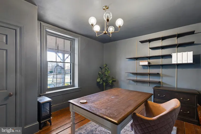 a kitchen with a table chairs and a chandelier