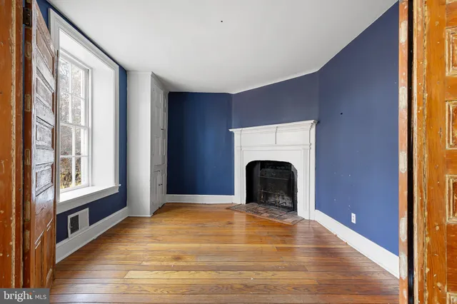 a view of empty room with window and fireplace
