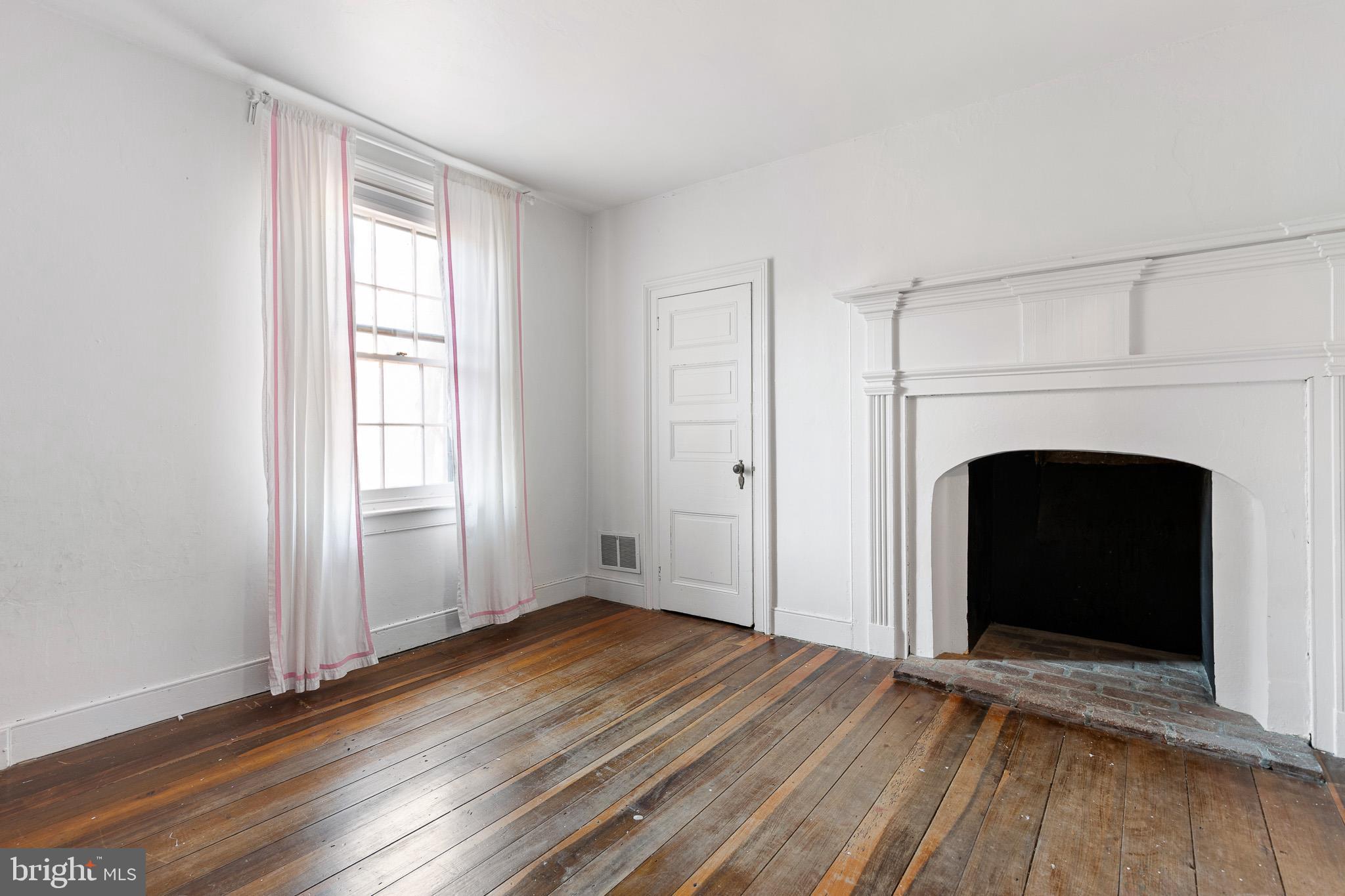 547 Concord Road Glen Mills, PA 19342 - Photo 7 of 42 a view of a livingroom with wooden floor and a fireplace