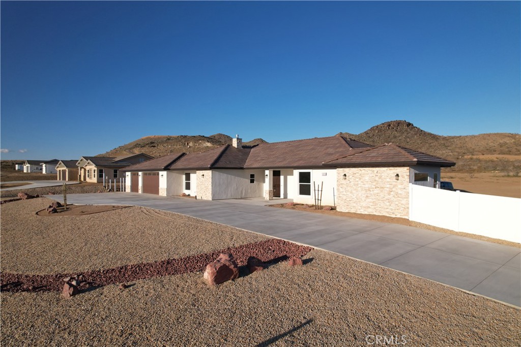 16735 Choco Road Apple Valley, CA 92307 - Photo 1 of 1 a front view of a house with a yard and garage