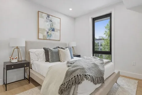 a bedroom with bed and a window