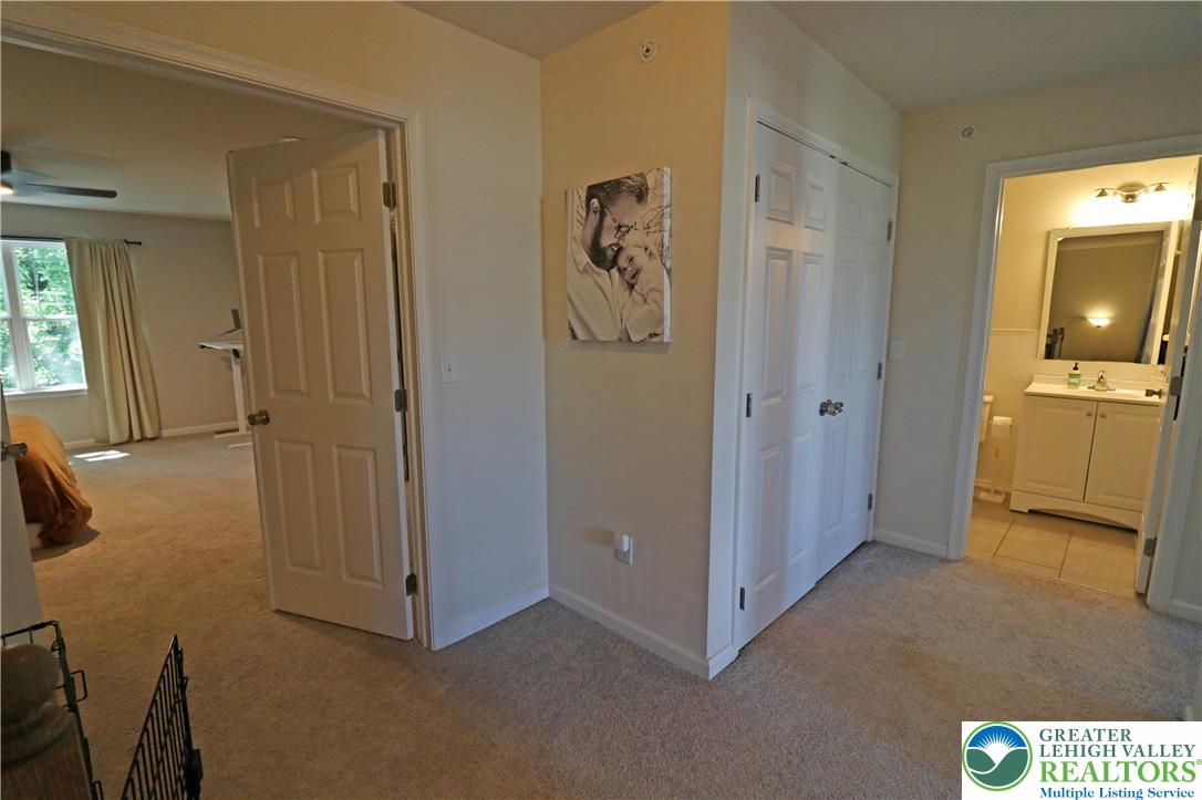 4502 Benjamin Court Emmaus, PA 18049 - Photo 23 of 53 Plush carpeting unites this private bedroom and adjoining tiled bathroom, offering comfort and convenience.