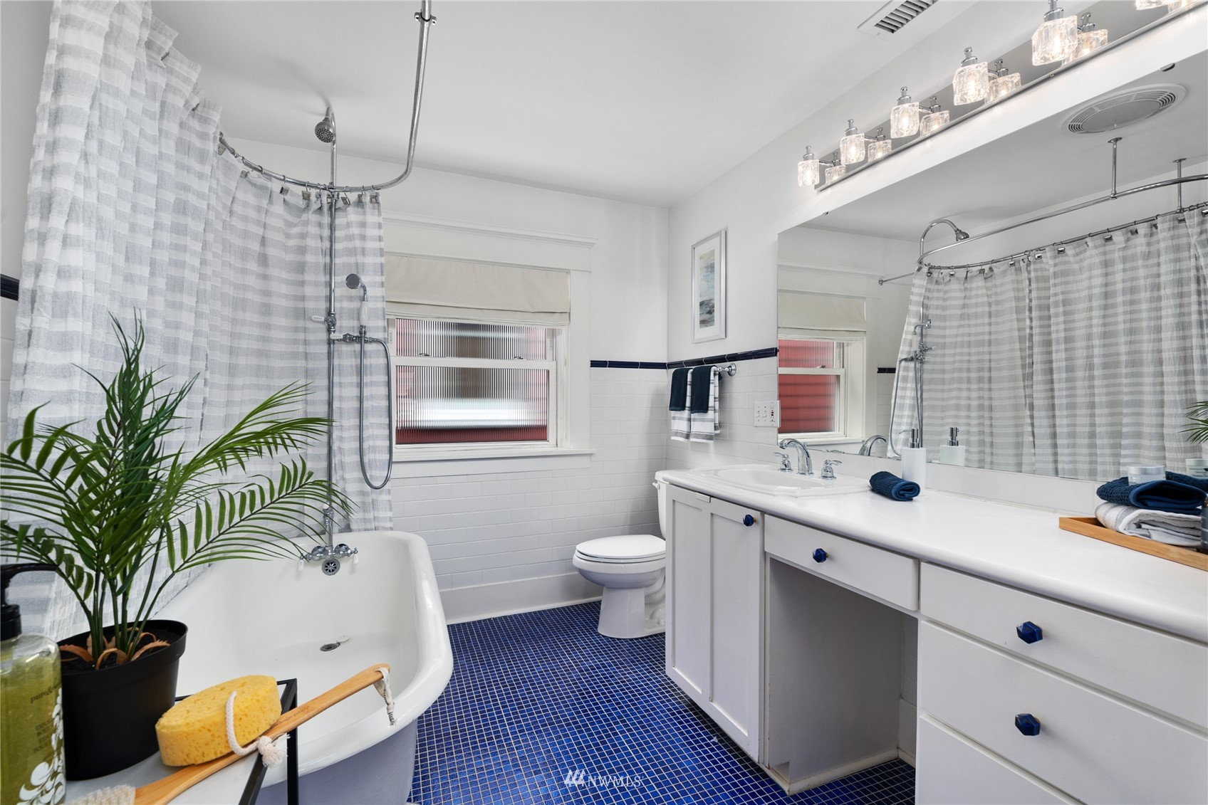 2419 2nd Avenue West Seattle, WA 98119 - Photo 14 of 30 a spacious bathroom with a granite countertop sink a toilet a mirror and shower