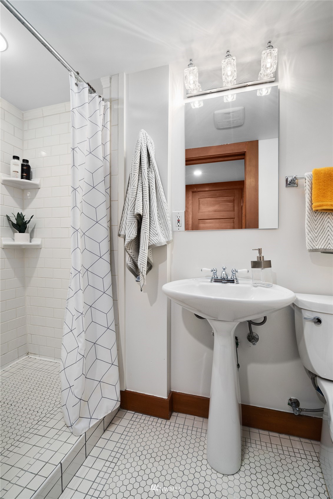 2419 2nd Avenue West Seattle, WA 98119 - Photo 19 of 30 a bathroom with a sink a mirror and shower