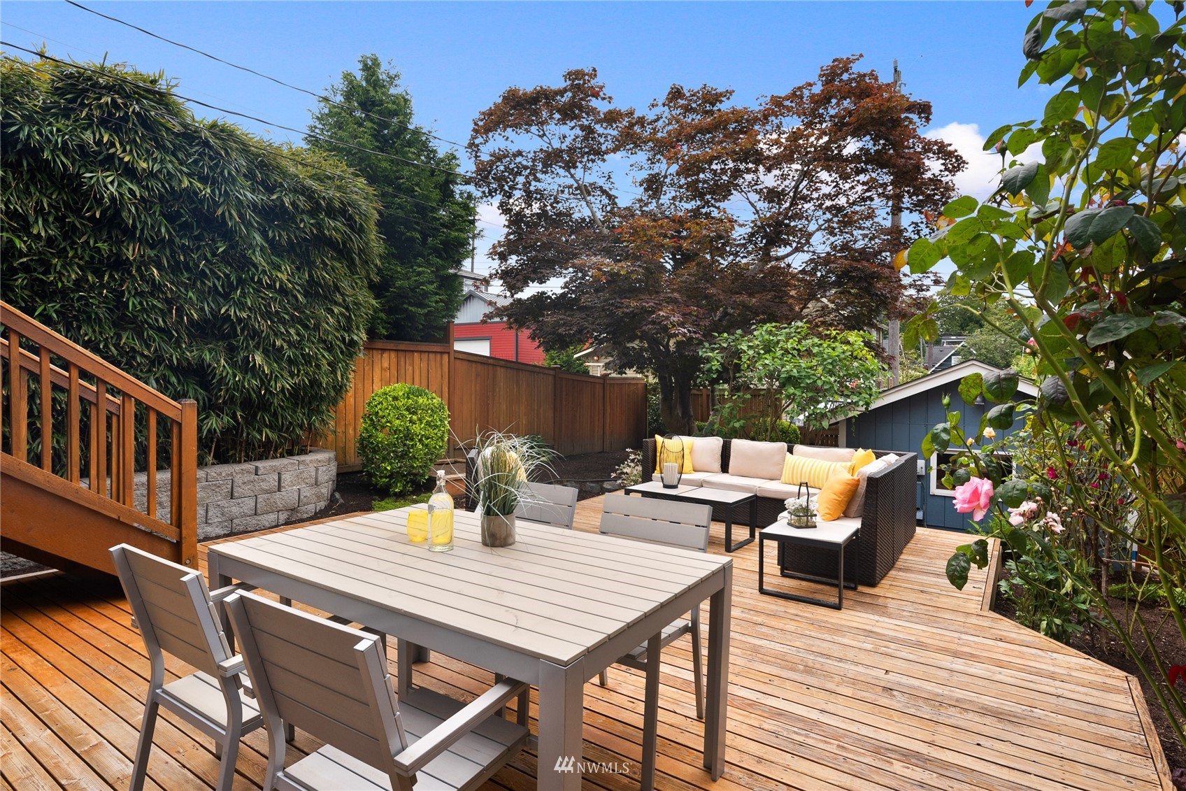 2419 2nd Avenue West Seattle, WA 98119 - Photo 24 of 30 a view of a patio with table and chairs with wooden floor and fence
