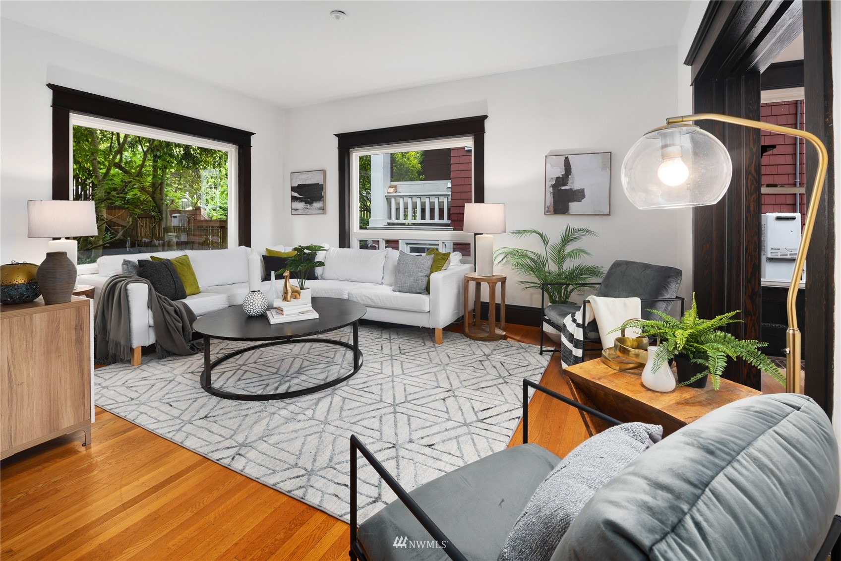 2419 2nd Avenue West Seattle, WA 98119 - Photo 6 of 30 a living room with furniture potted plant and a large window