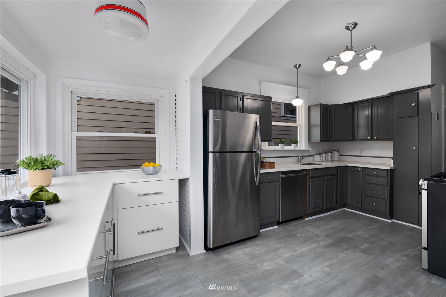 2419 2nd Avenue West Seattle, WA 98119 - Photo 8 of 30 a kitchen with stainless steel appliances granite countertop a refrigerator sink and stove