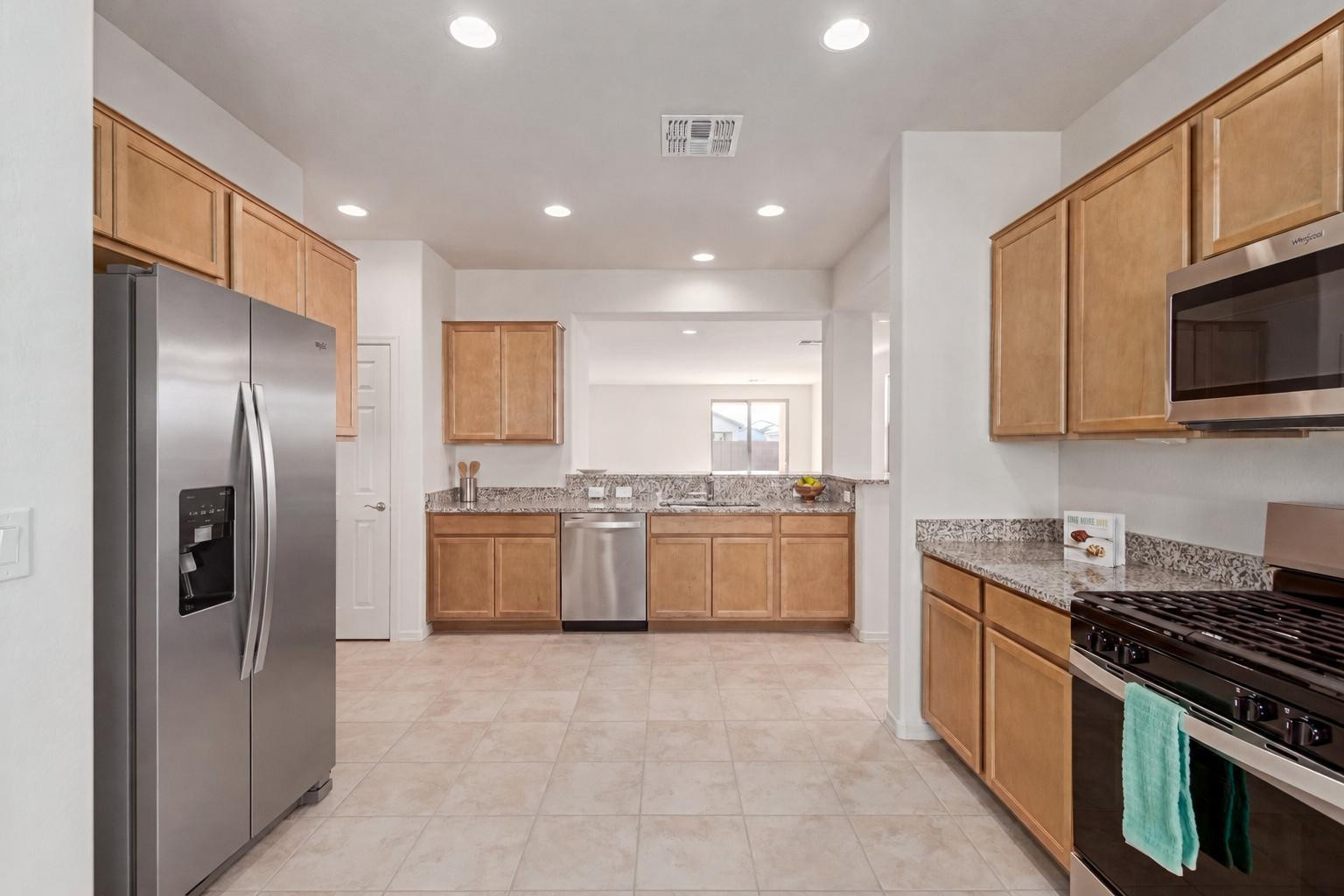 7143 West Coles Road Laveen, AZ 85339 - Photo 1 of 15 a kitchen with stainless steel appliances granite countertop a refrigerator a sink a stove top oven and cabinets
