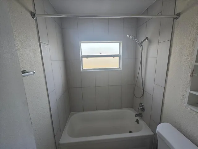 a bathroom with a bathtub and a shower