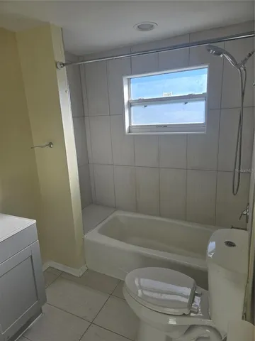 a bathroom with a toilet and a bathtub
