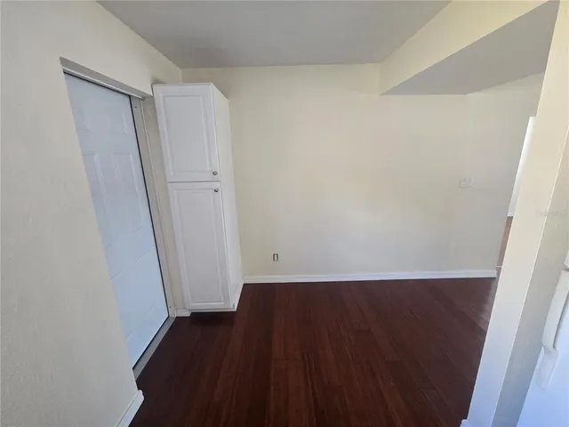 an empty room with wooden floor and a window