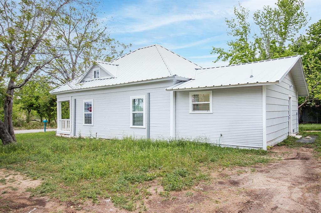 607 West 6th Street Brady, TX 76825 - Photo 28 of 32 a view of a house with a yard plants and large tree