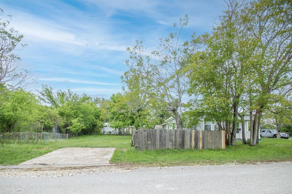 607 West 6th Street Brady, TX 76825 - Photo 31 of 32 a view of backyard with wooden fence and large trees