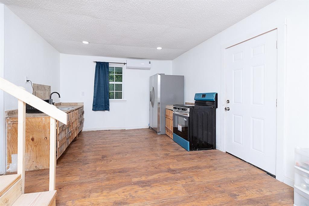607 West 6th Street Brady, TX 76825 - Photo 6 of 32 a view of a kitchen with refrigerator and a sink