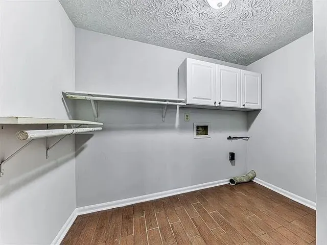 a view of storage and utility room with wooden floor