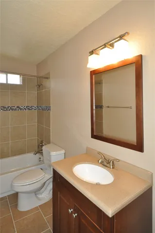a bathroom with a sink toilet vanity and shower