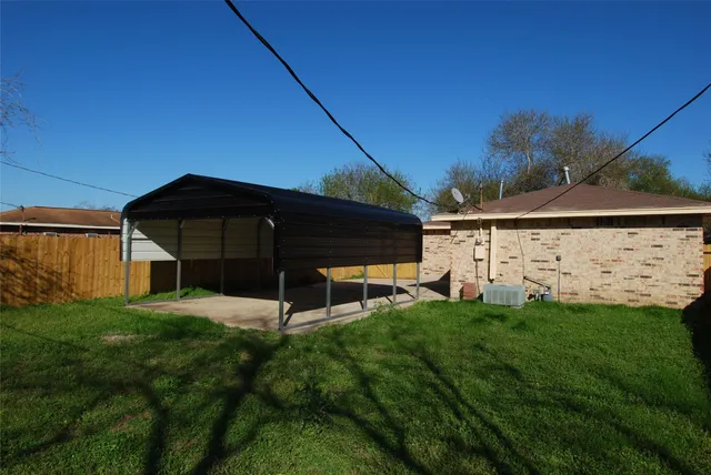 a view of a back yard of the house with a yard