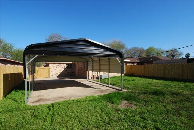 a view of a backyard with a garden and entertaining space