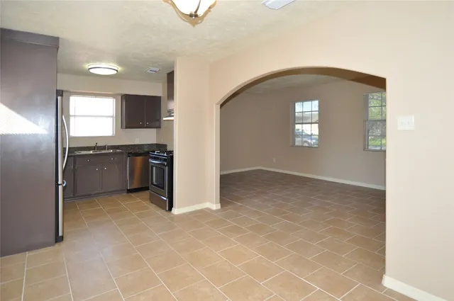 an empty room with windows and entrance