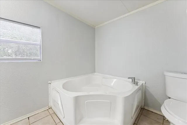 a white bath tub sitting next to a toilet