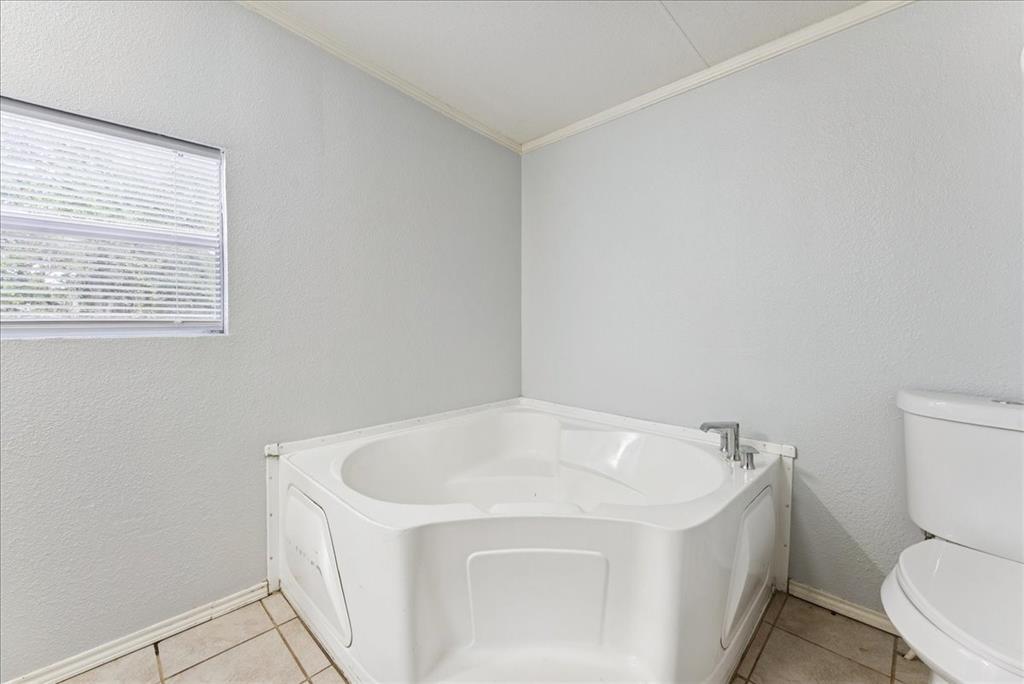 107 Hidden View Court Springtown, TX 76082 - Photo 13 of 24 a white bath tub sitting next to a toilet