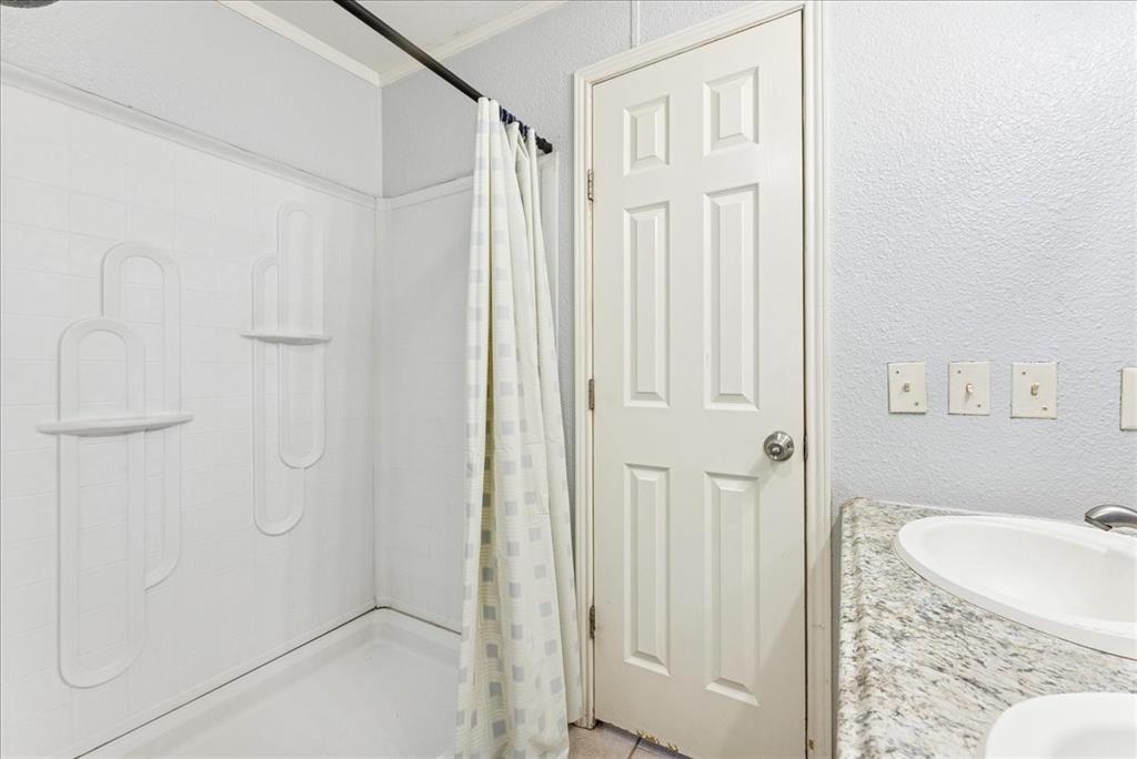 107 Hidden View Court Springtown, TX 76082 - Photo 14 of 24 a bathroom with a granite countertop shower and a sink