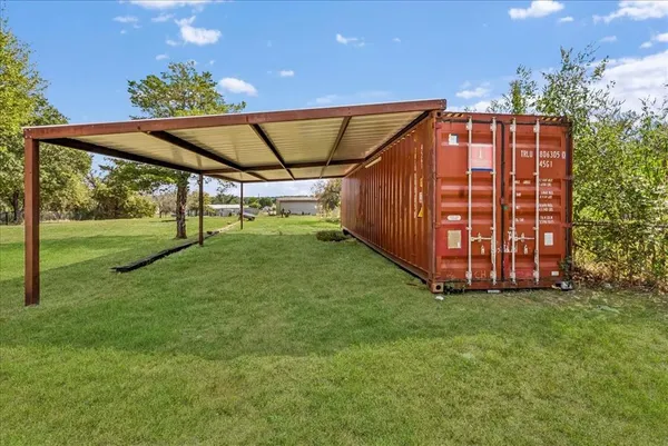 a view of a backyard with garden and deck